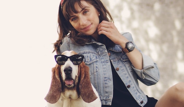 woman in jean jacket with beagle dog wearing sunglasses