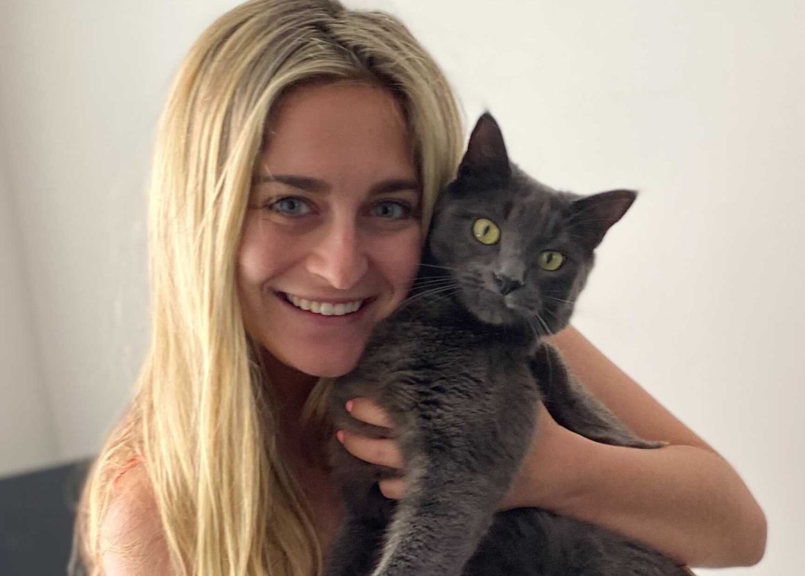 girl hugging grey cat