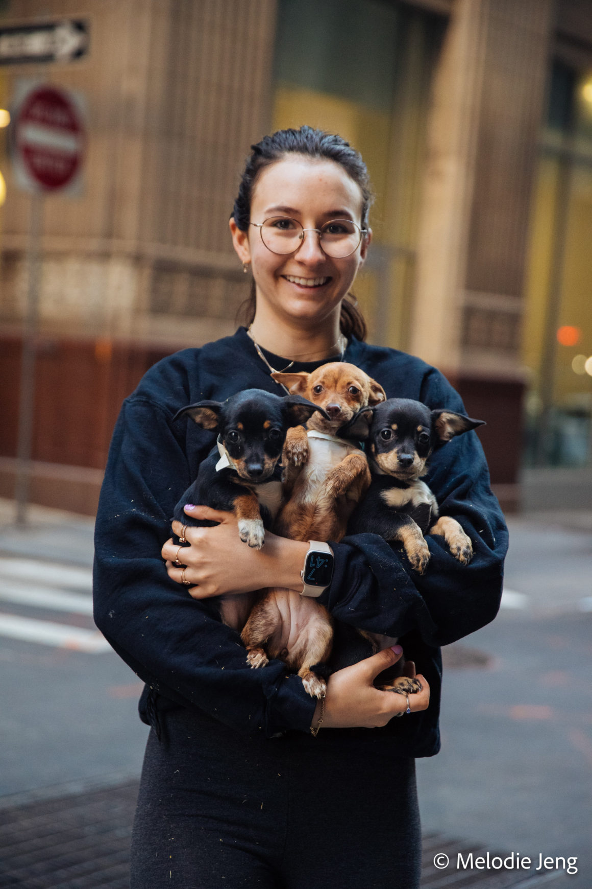 woman holding puppies