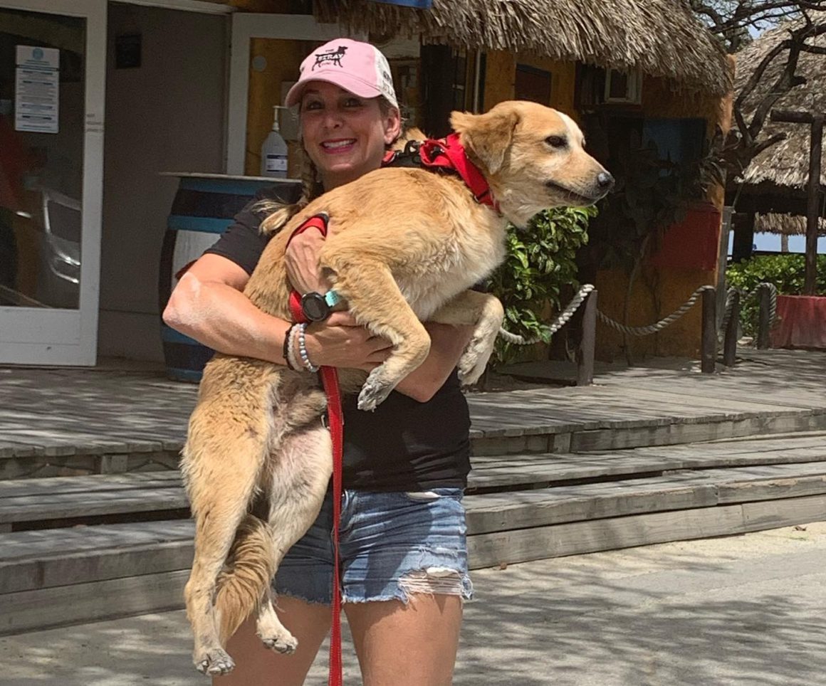 woman holding large dog