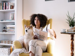 woman sitting in chair with dog