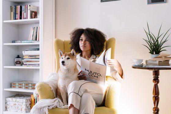 woman sitting in chair with dog