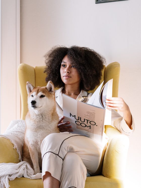 woman sitting in chair with dog